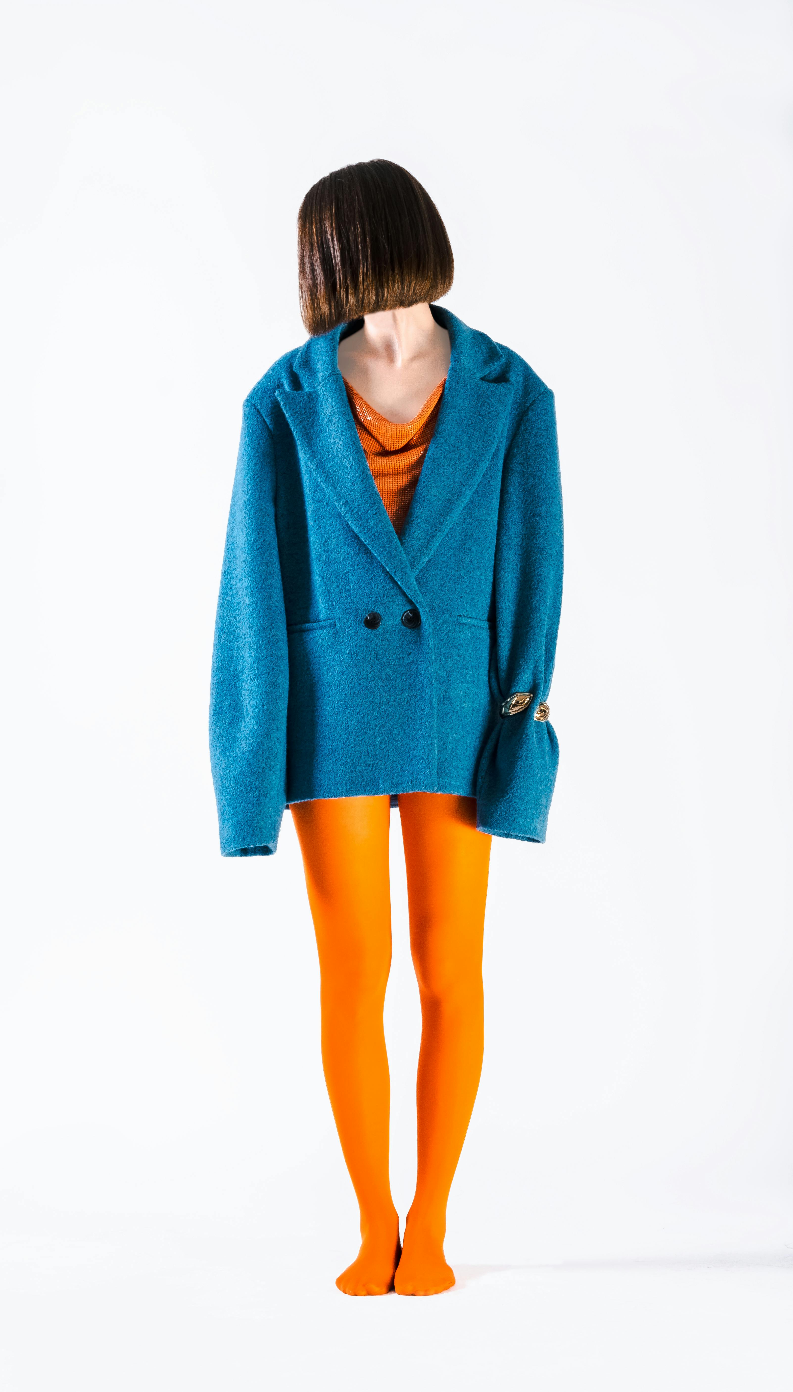 Creative fashion portrait with blue jacket and orange tights in Istanbul.