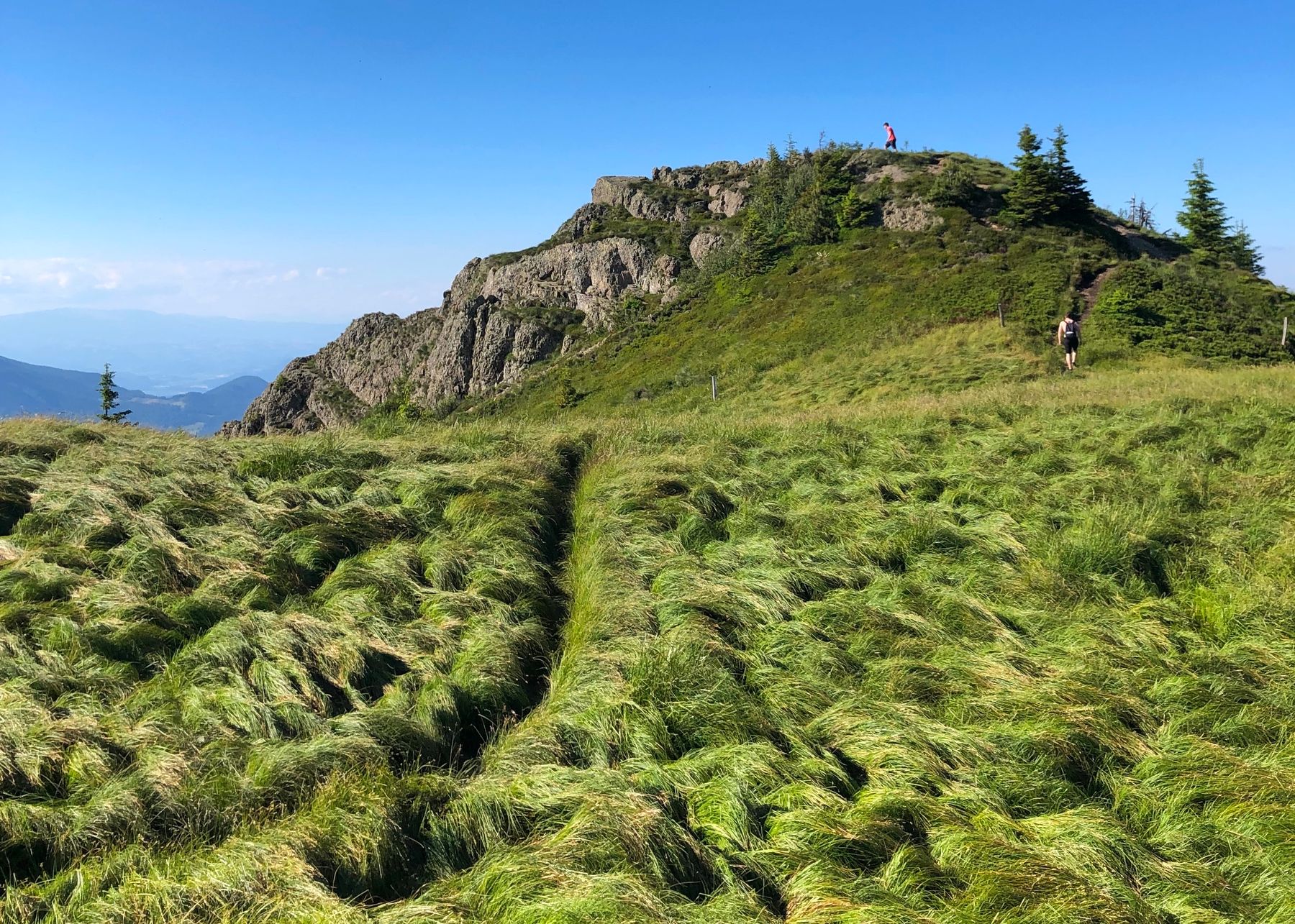 Hikers walking through a Slovenian mountain landscape
