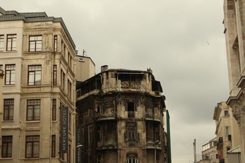 Free Contrast of historic decay and modern architecture in urban street scene. Stock Photo
