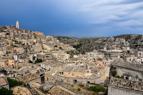 Free Explore the breathtaking ancient architecture of Matera in Apulia, Italy, under a striking sky. Stock Photo