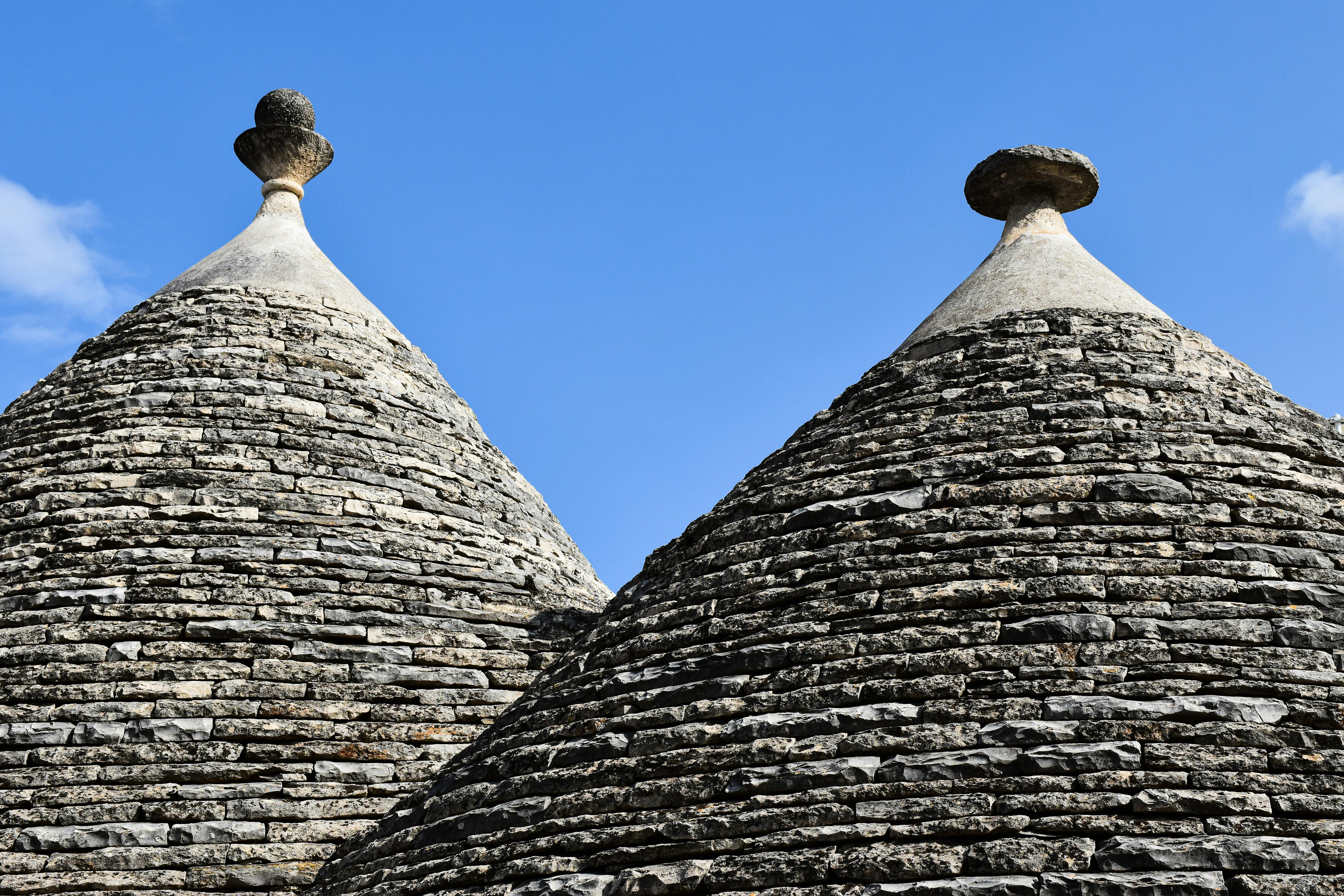 Close-up of iconic Trulli roofs in Alberobello, showcasing unique conical architecture.