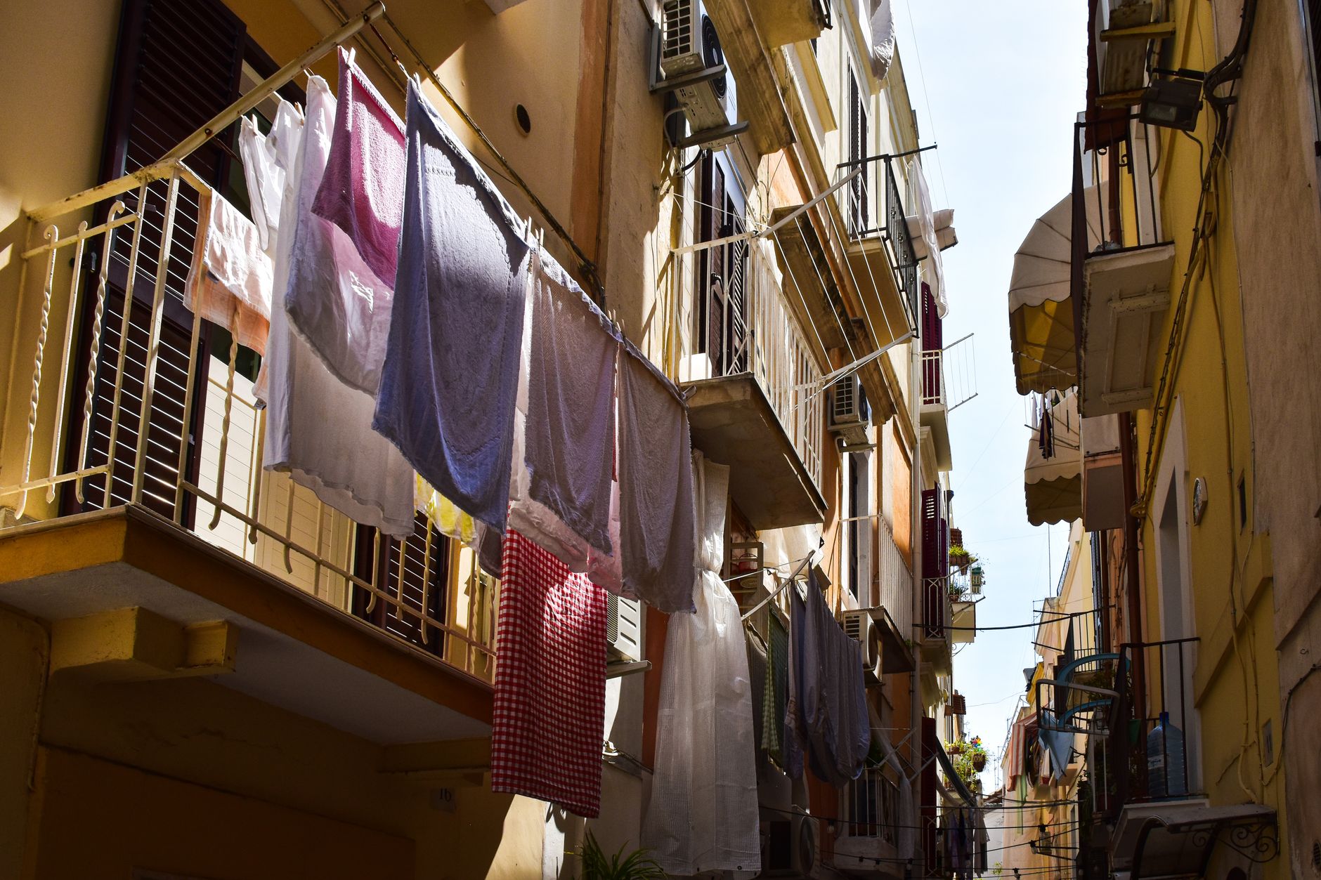 Clothes drying in a charming alley in Apulia, Italy, showcasing local life.