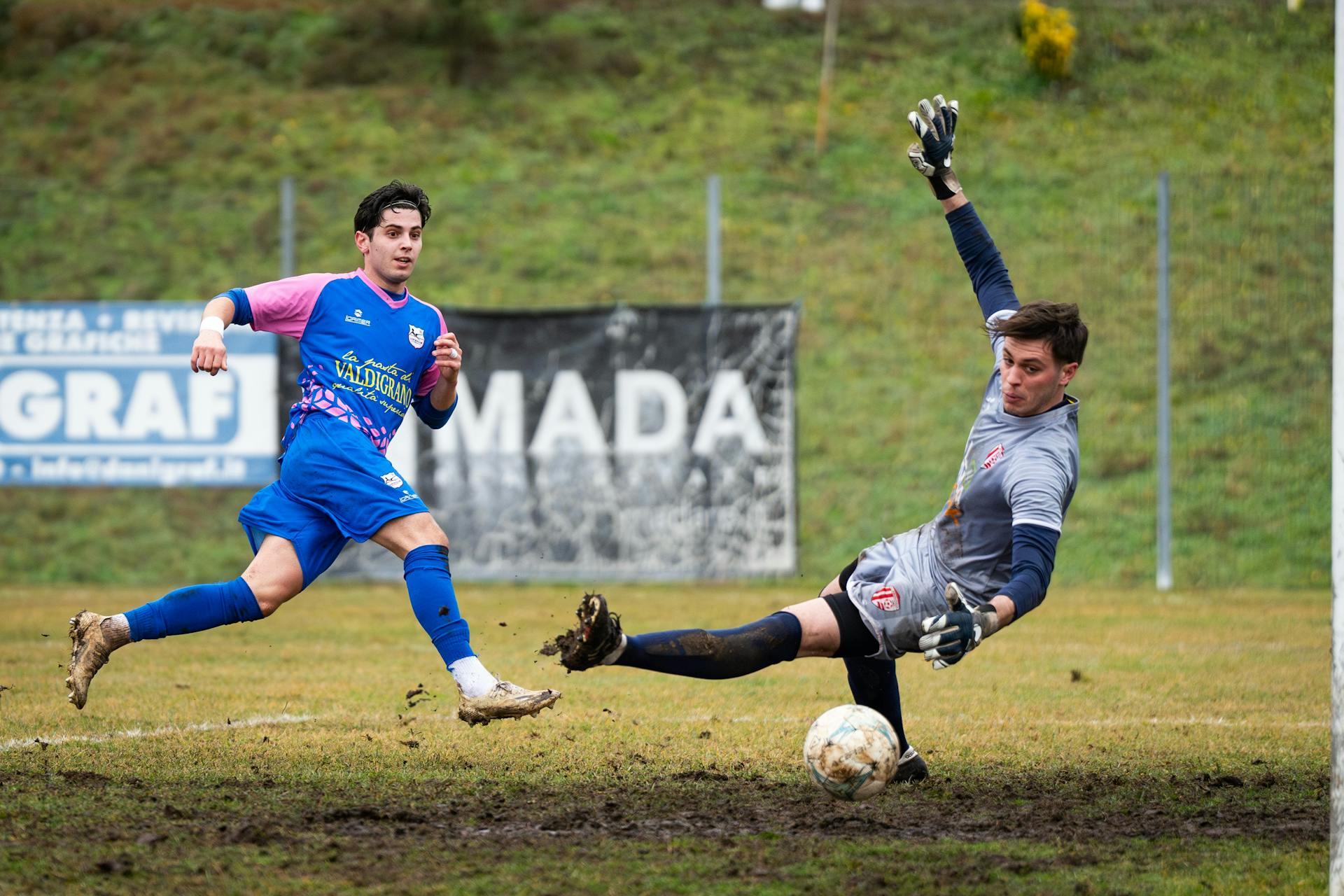 Action-packed soccer moment with goalkeeper making a dramatic save on the field.