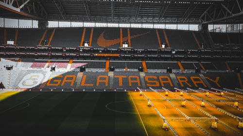 Free Interior view of Galatasaray Stadium in Istanbul featuring team logo and seating area. Stock Photo