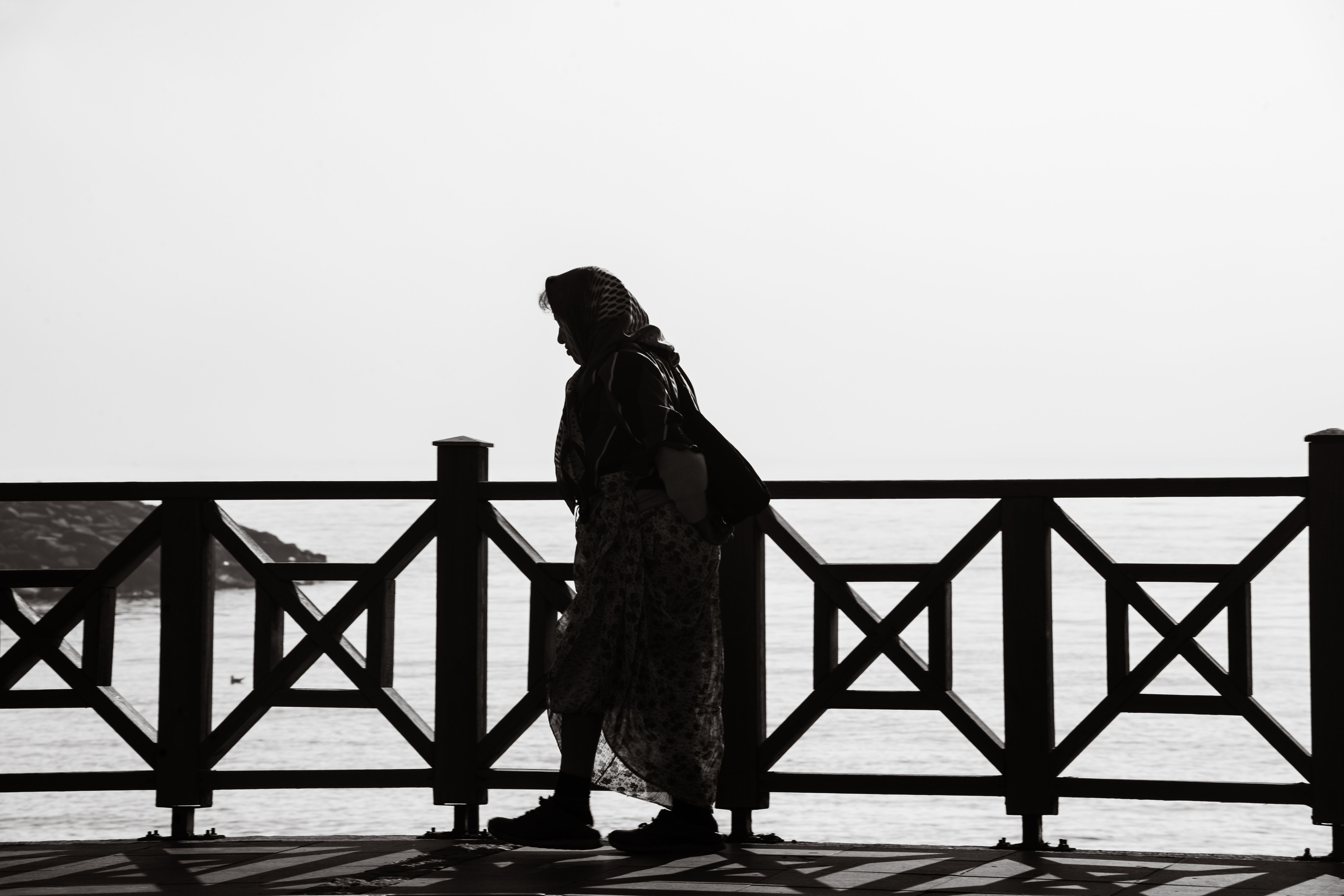 Silhouette of Woman Walking by the Sea · Free Stock Photo