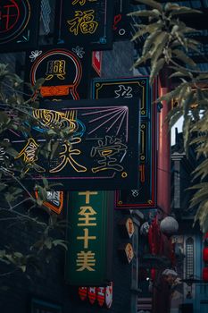 Colorful neon signs illuminate Jakarta's Chinatown, showcasing traditional Chinese aesthetics.