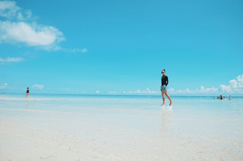 Person Standing on Seashore