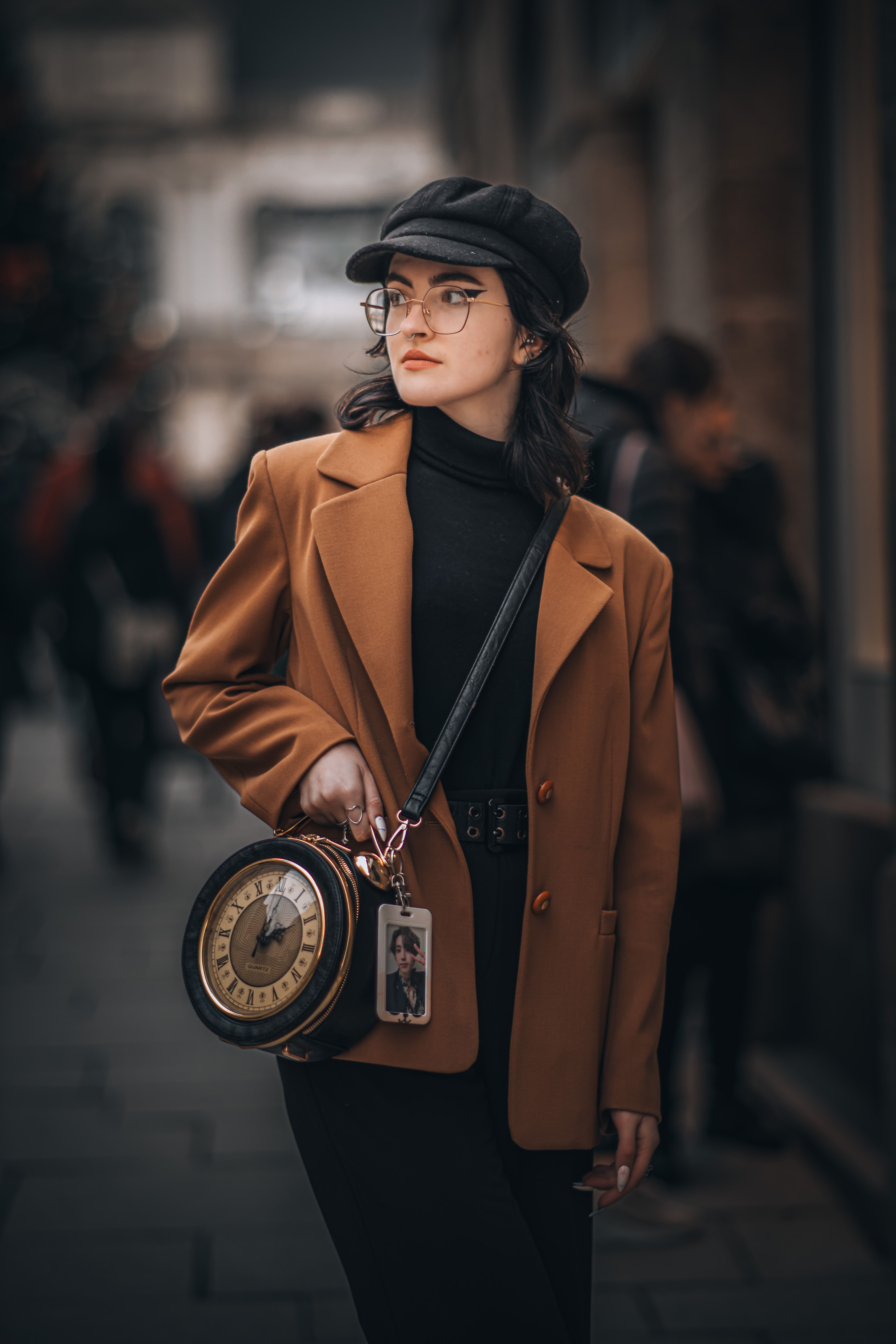 Stylish Woman with Clock Handbag on Urban Street · Free Stock Photo