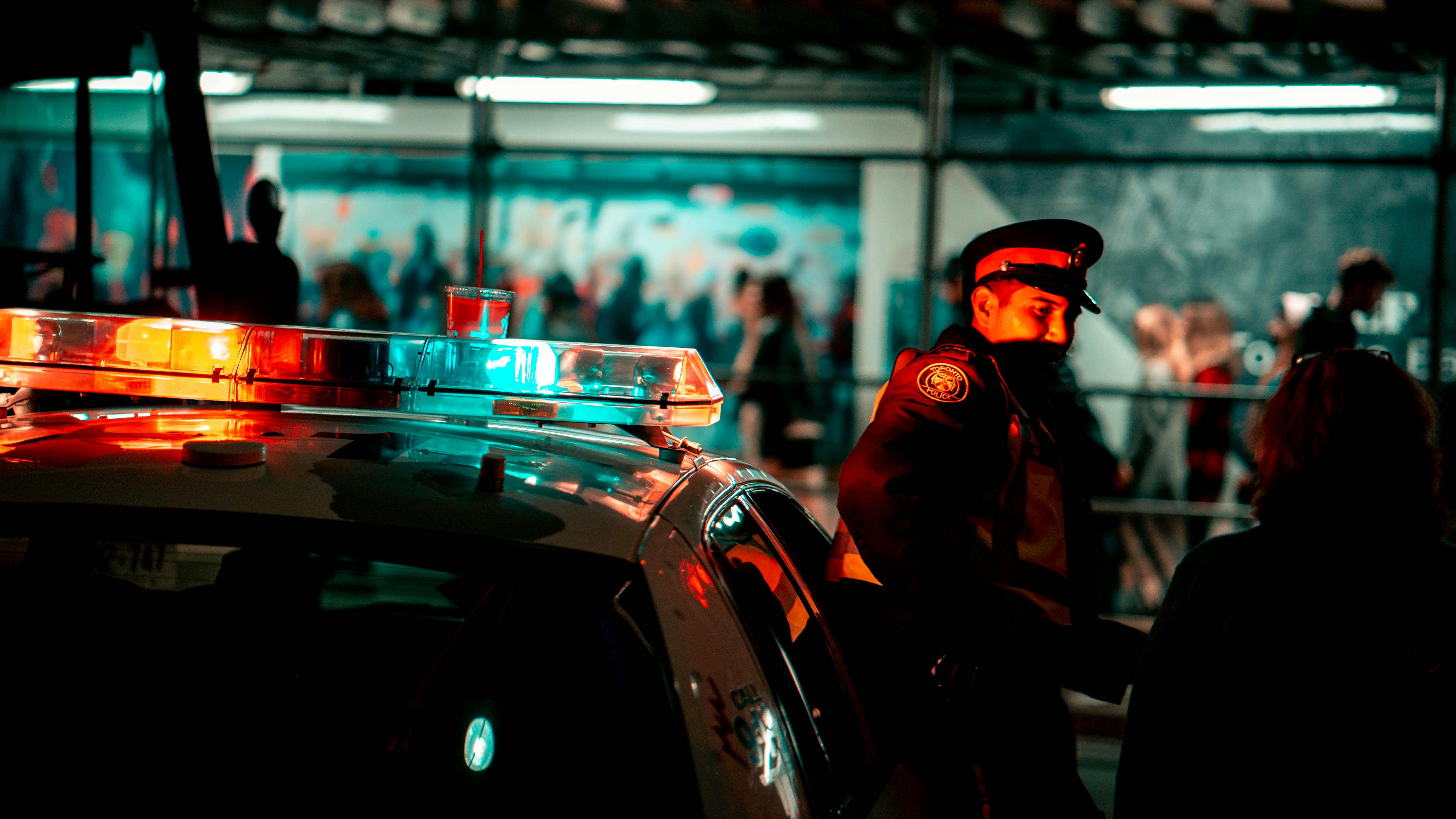 Police standing beside the police car. | Photo: Pexels