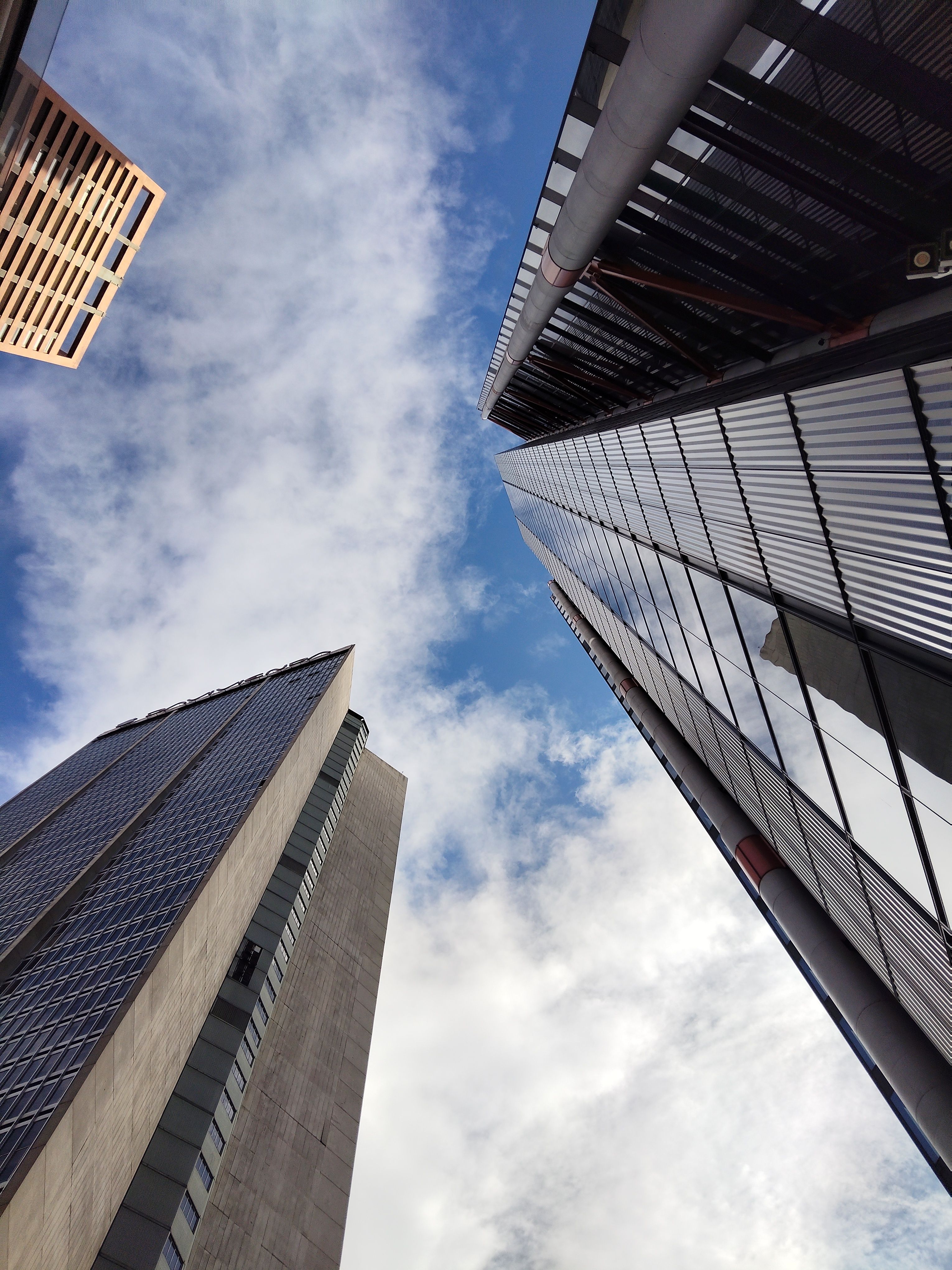 Skyscrapers Against a Cloudy Blue Sky · Free Stock Photo