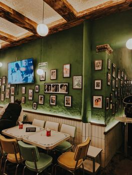 Warm vintage restaurant interior with framed photos and cozy lighting, ideal for nostalgic themes.