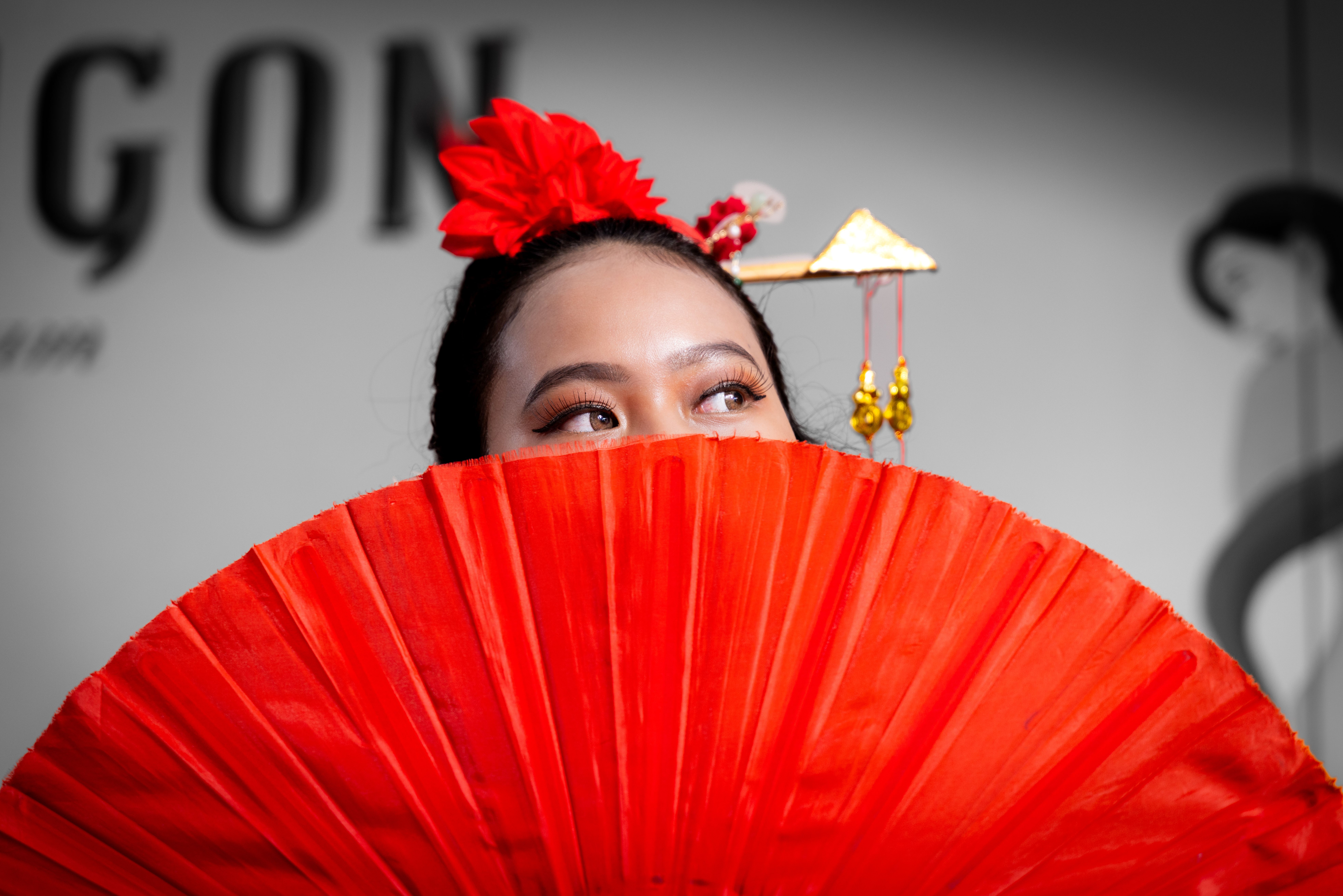 Elegant Woman with Red Fan at Cultural Event · Free Stock Photo