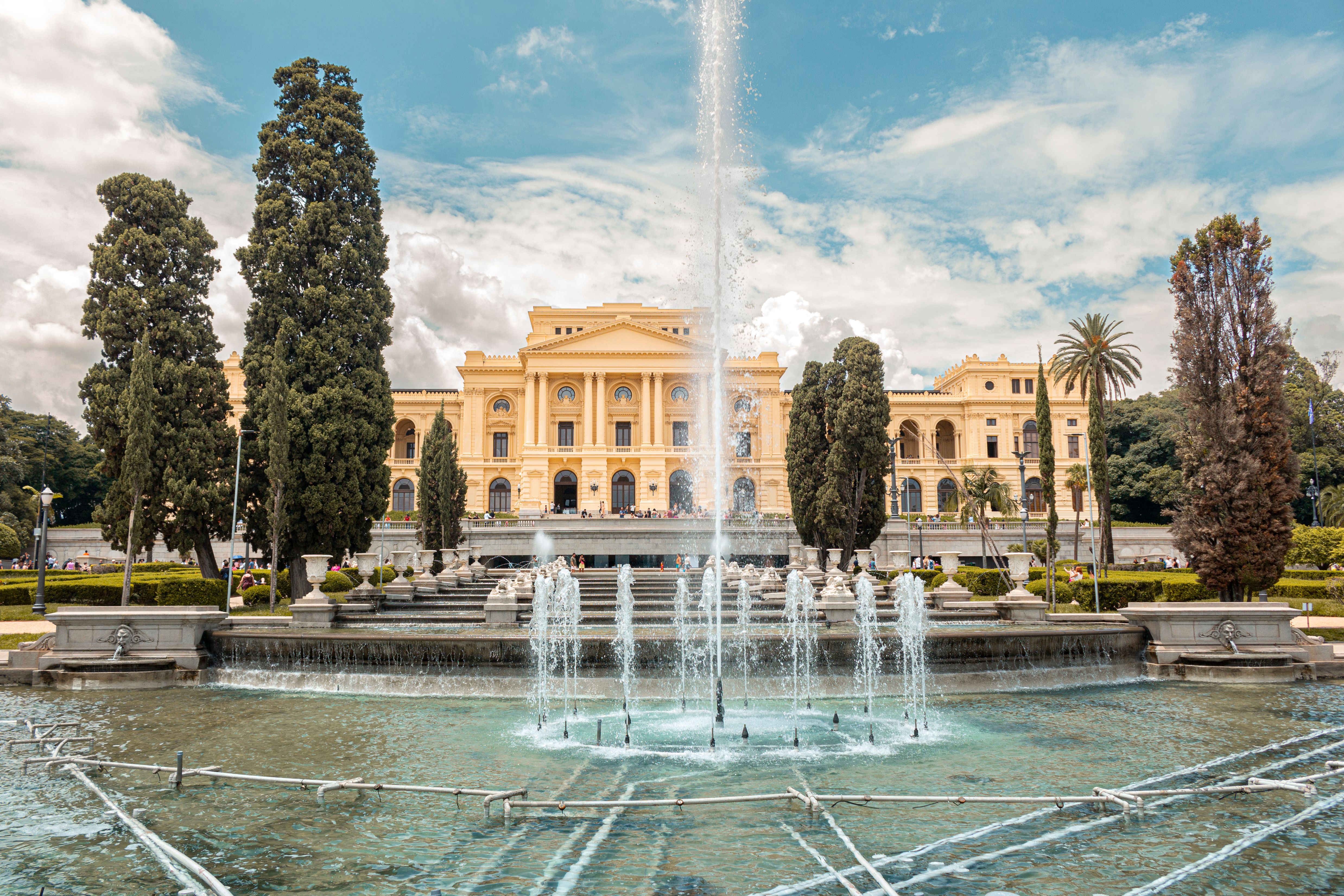 Wide-angle view of the historic Ipiranga Museum with a grand fountain in São Paulo, Brazil.