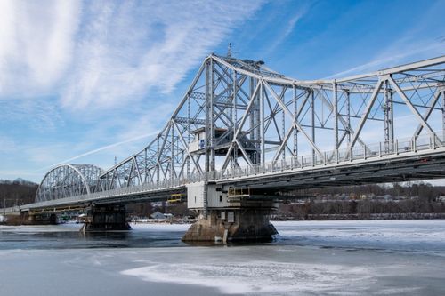 Free Scenic view of the East Haddam Swing Bridge in winter with icy river and clear sky. Stock Photo
