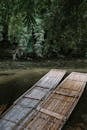 Two Long Bamboo Rafts by The Side Of A Shallow River