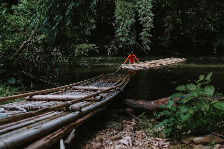 Man Placing A Raft On Body Of Water