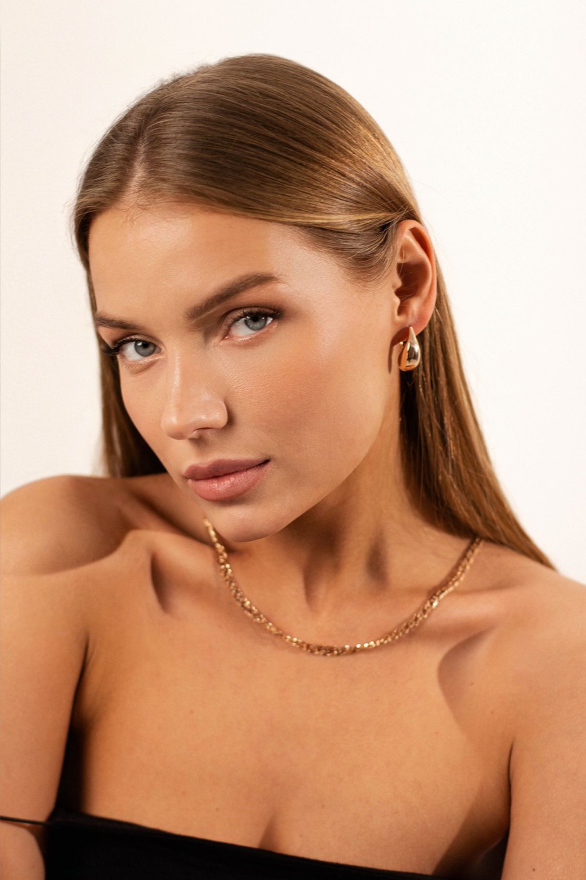 Close-up of rings worn on a necklace