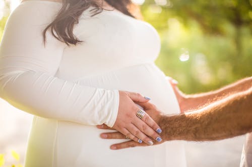 Husband Holding Her Wife's Belly