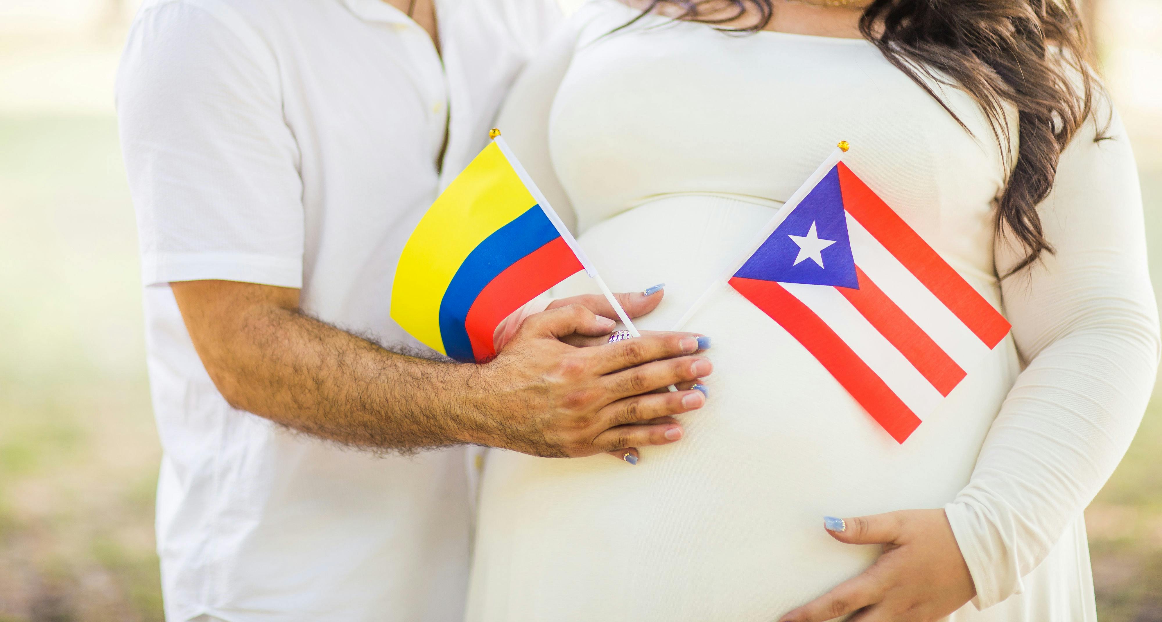 pregnant woman and husband holding flaglets