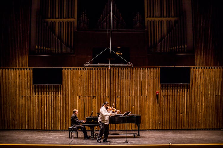 Man Playing Grand Piano On Stage