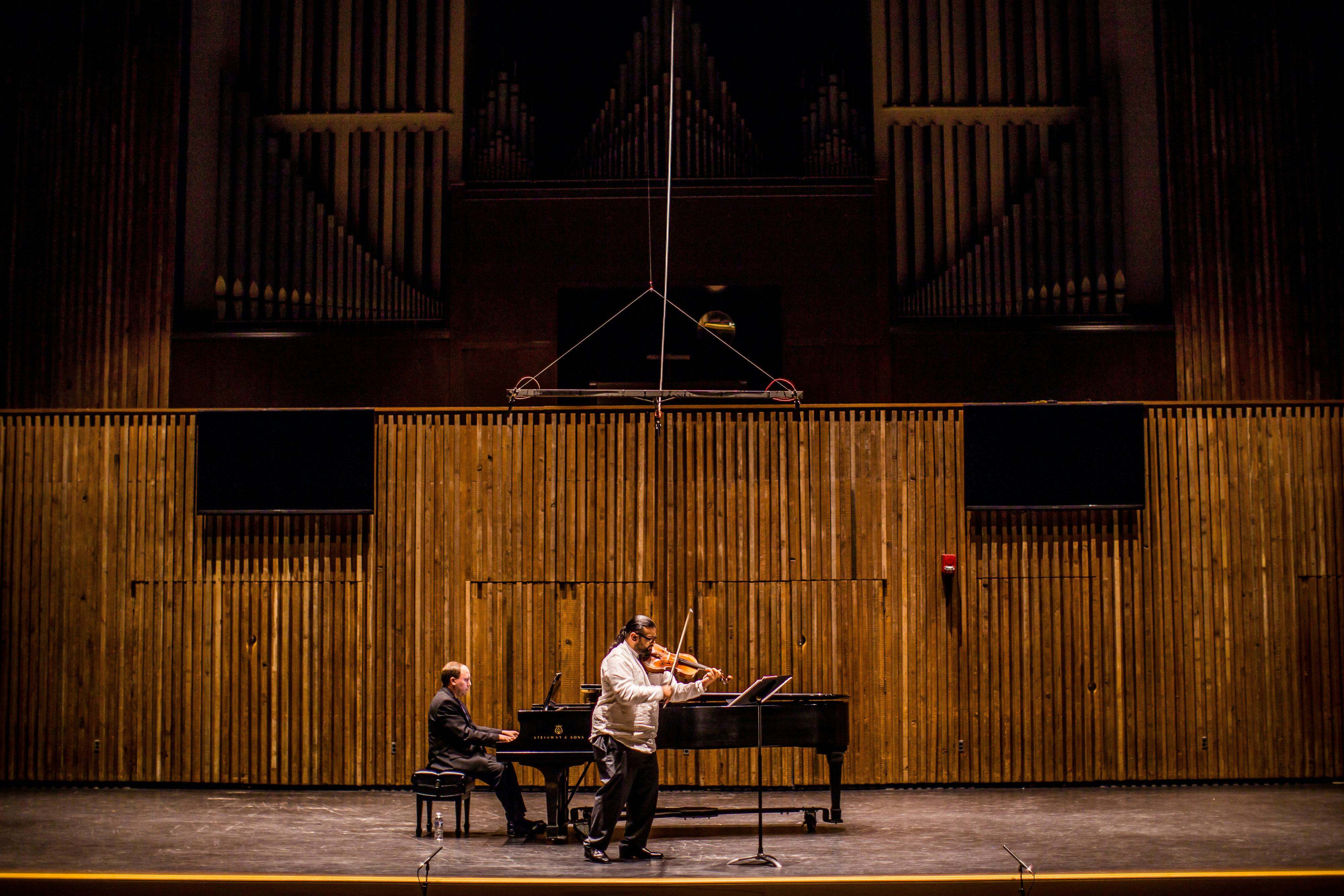 Man Playing Grand Piano On Stage · Free Stock Photo