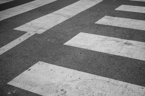 Free Black and white image of a crosswalk pattern on asphalt, emphasizing lines and texture. Stock Photo