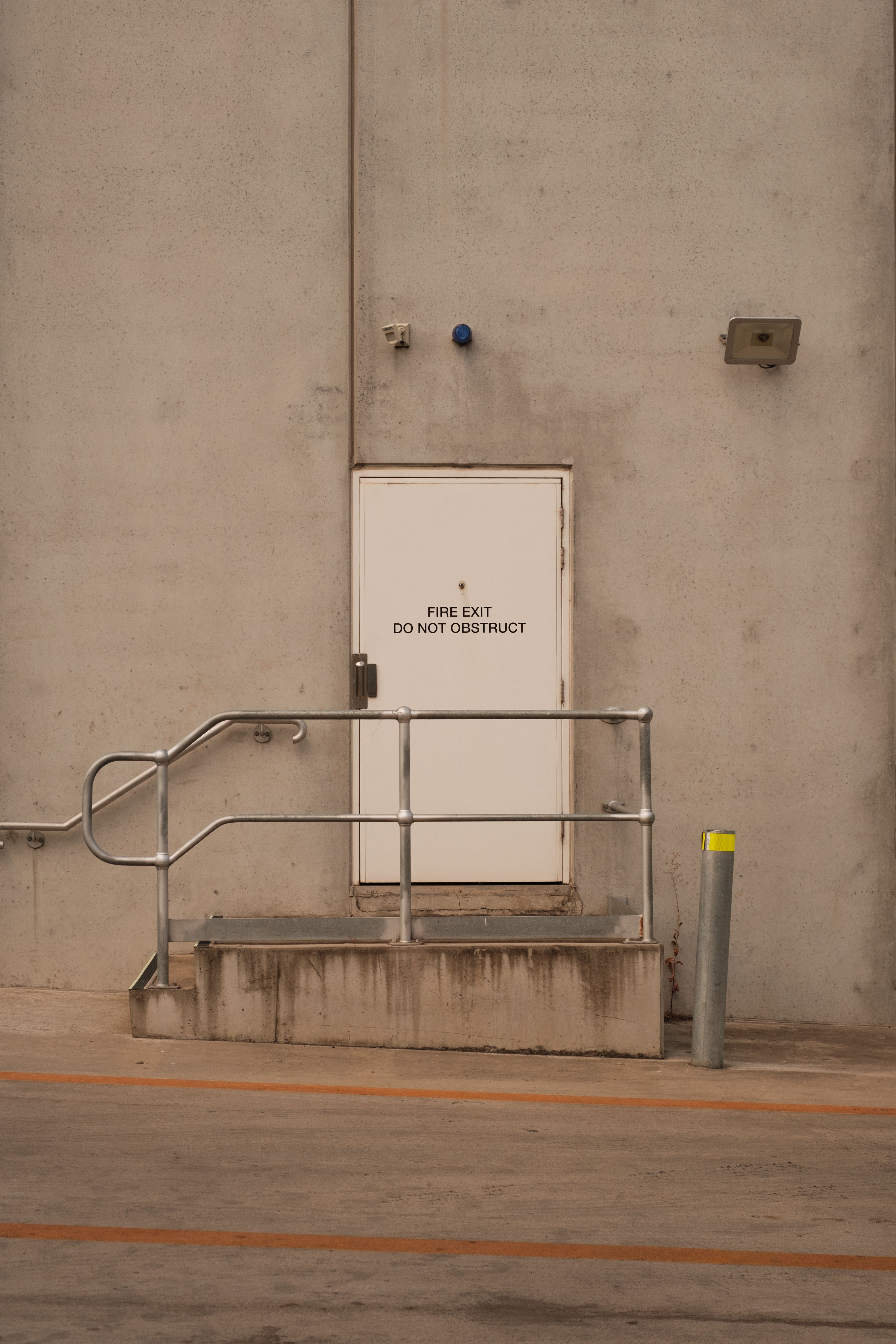 Industrial Fire Exit Door with Metal Railing · Free Stock Photo