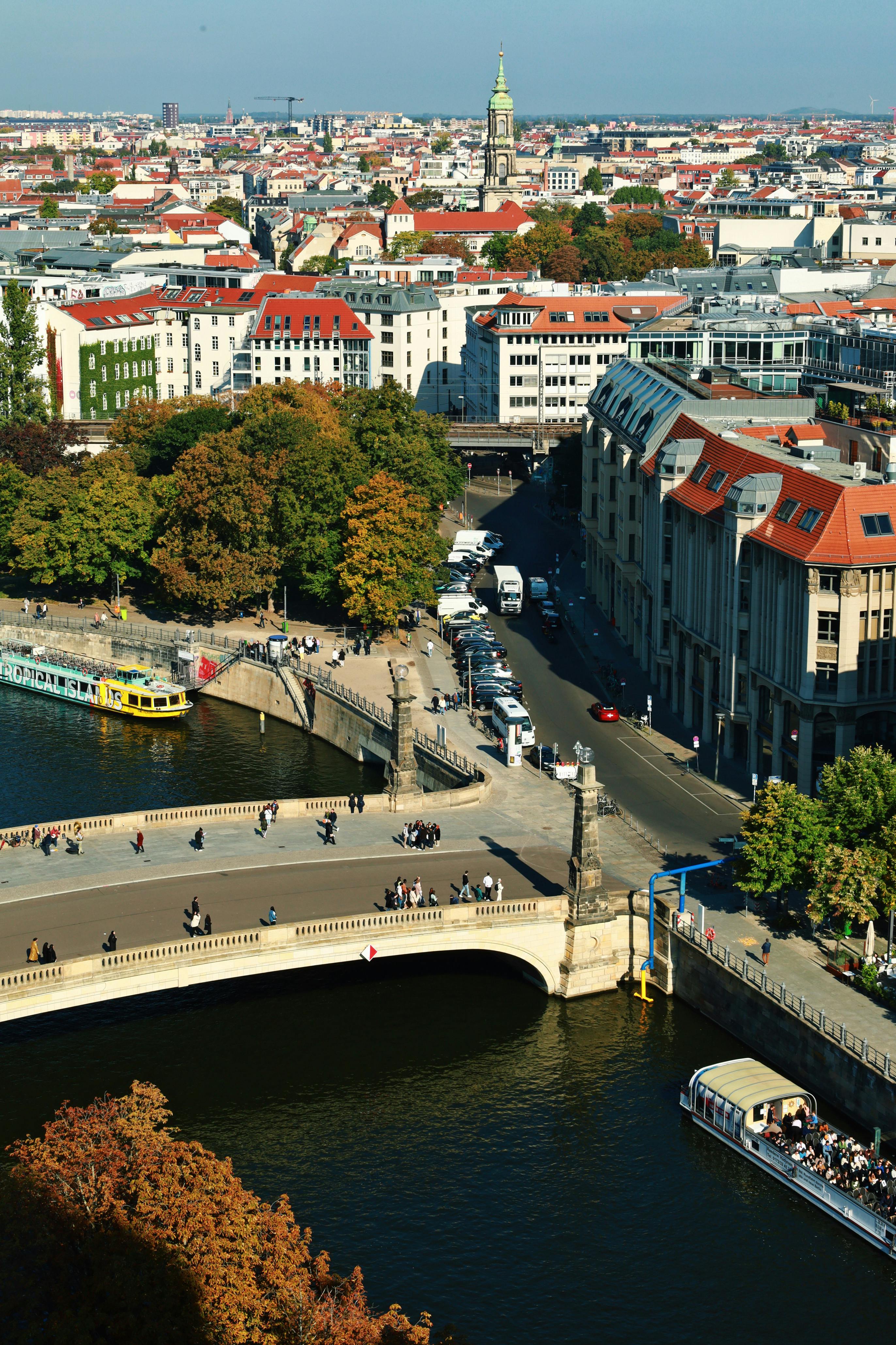 Aerial view showcasing Berlin's cityscape with the Spree River and iconic architectural landmarks.