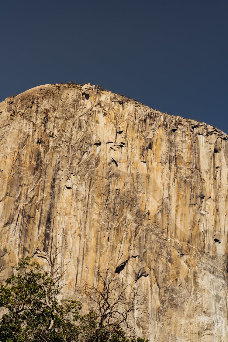  Low Angle Shot Of Rocky Mountain Cliff Under Blue Sky