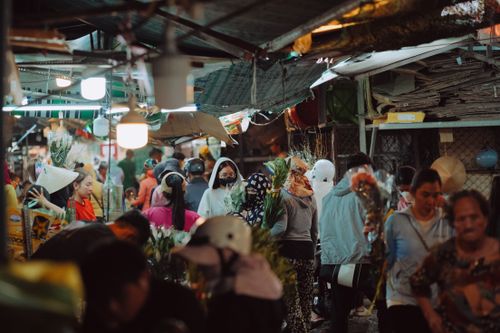 Free Crowded night market bustling with people buying and selling goods. Stock Photo