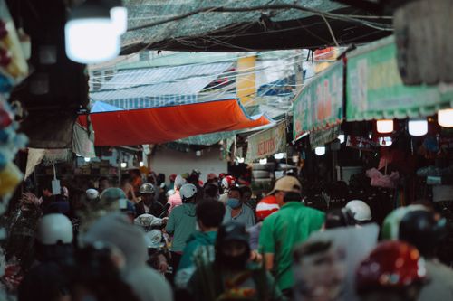 Free Vibrant market scene bustling with people in a colorful Asian street layout. Stock Photo