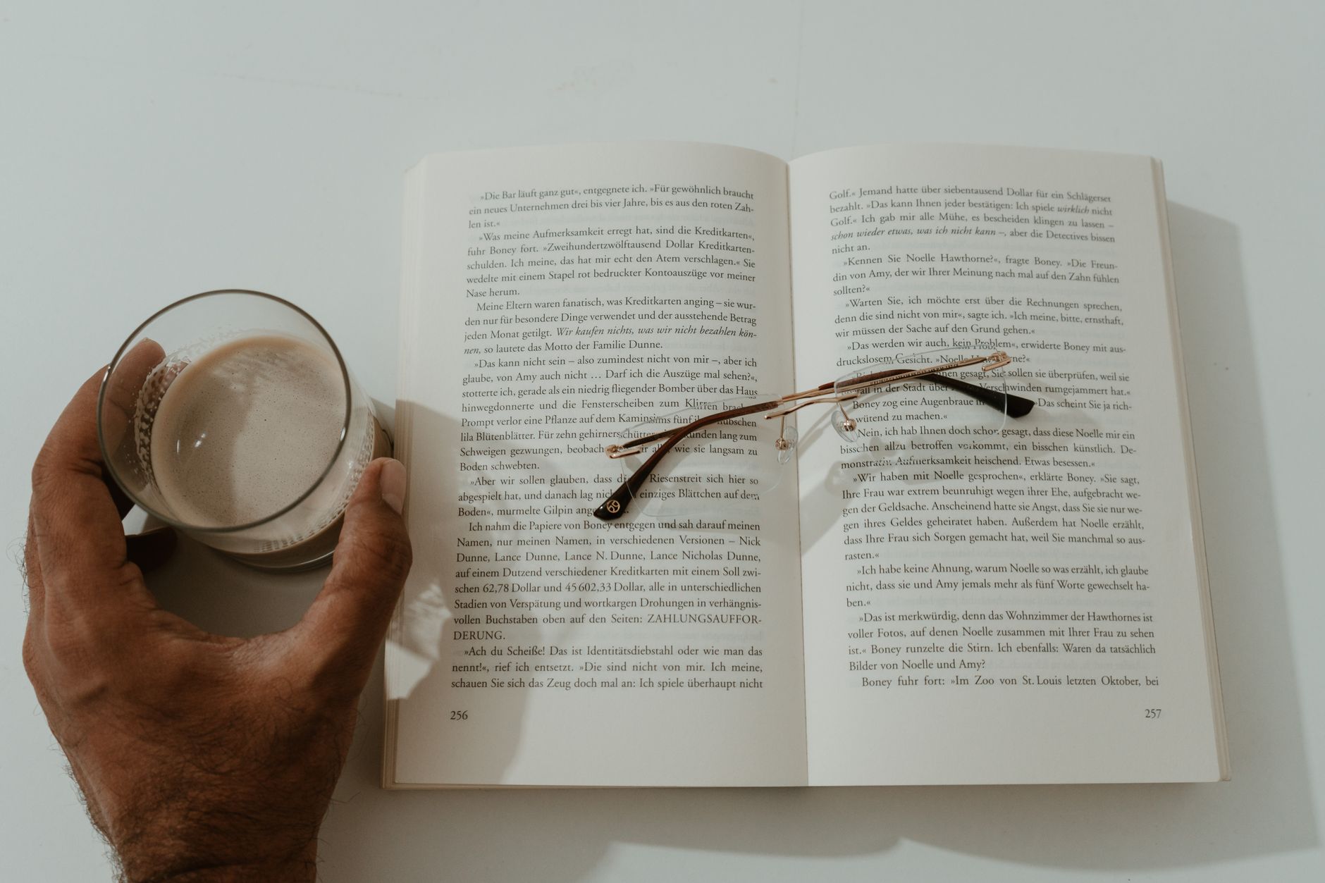Book on a table with coffee and glasses
