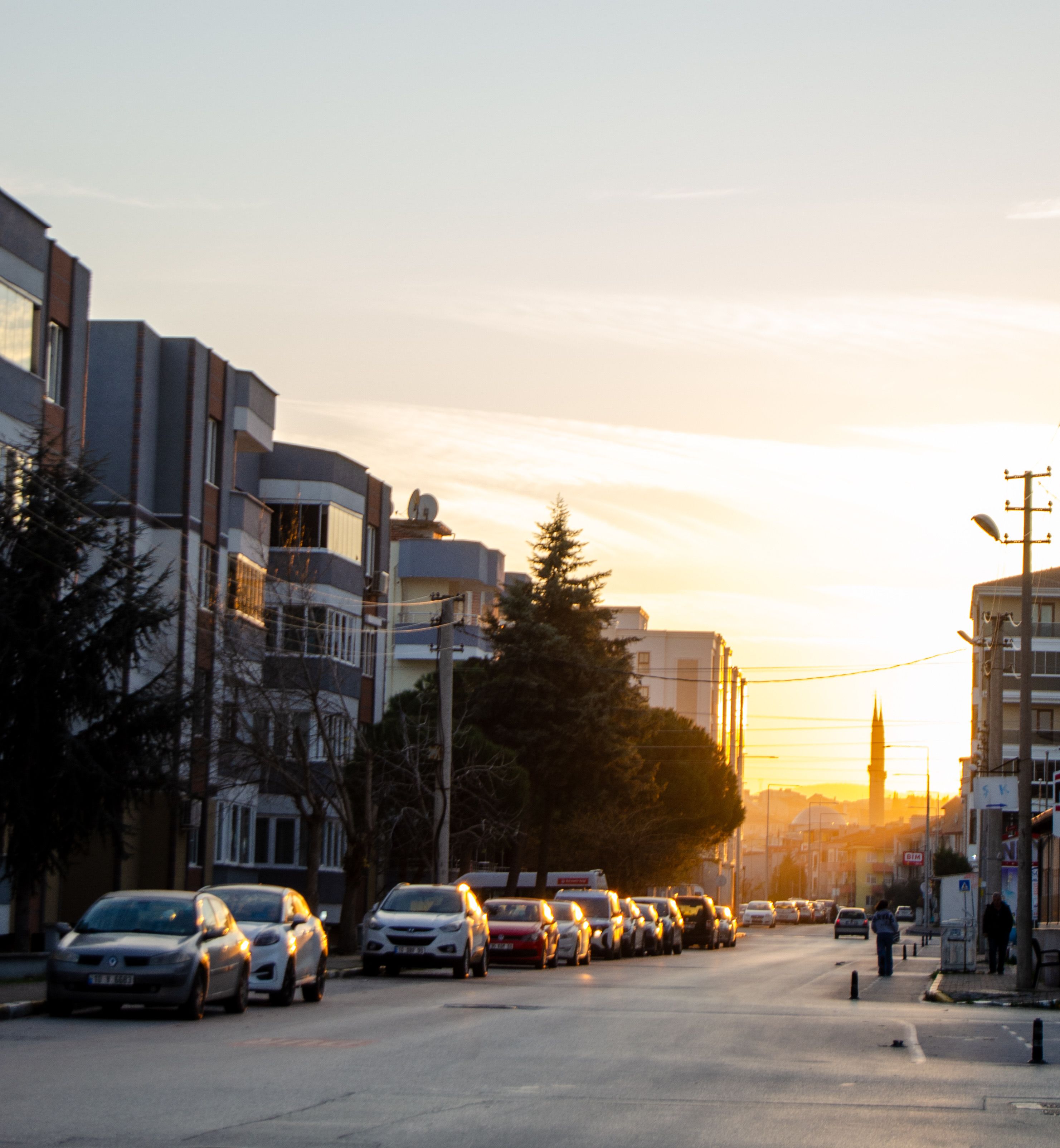 Sunset view on city street with parked cars · Free Stock Photo