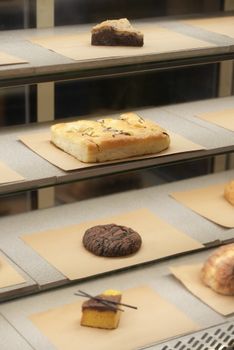 Freshly baked goods neatly arranged in a bakery display case showcasing variety.