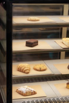 A variety of pastries and baked goods in a glass display case.