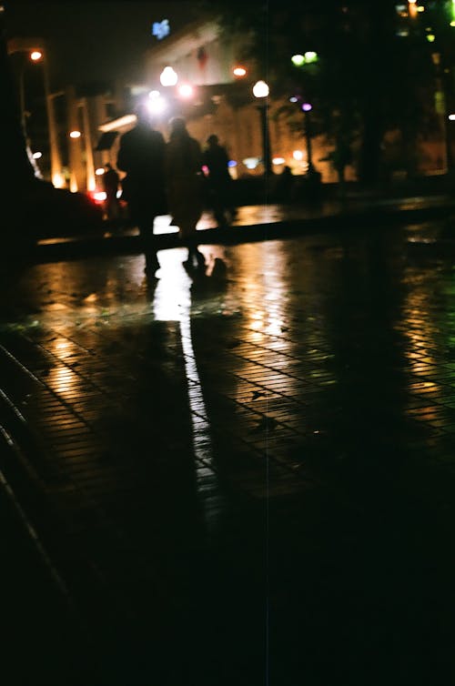 Free stock photo of after the rain, city lights, people walking Stock Photo