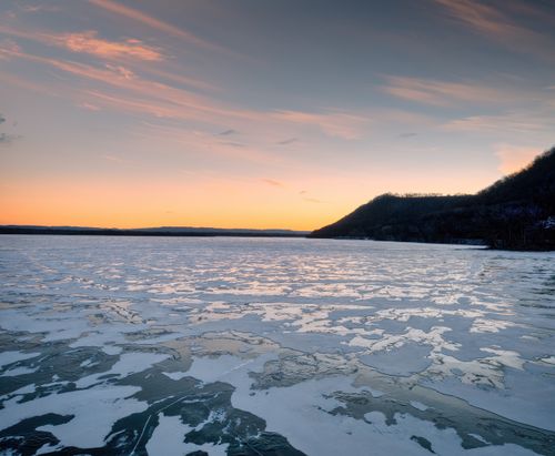Free Stunning sunset view over a frozen lake in Camp Lacupolis, Minnesota. Stock Photo