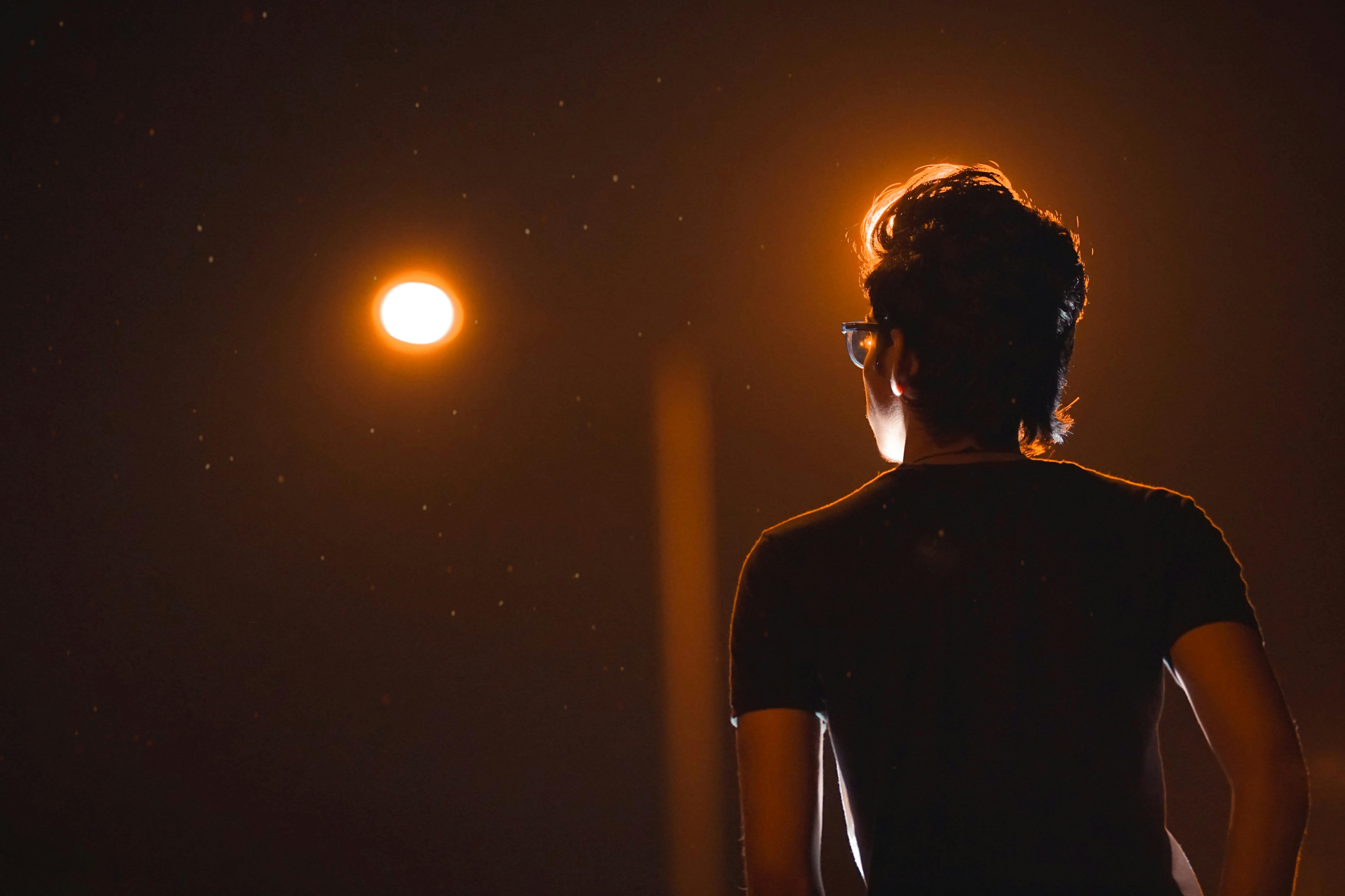 Back View Photo of Man in Glasses Posing During Night · Free Stock Photo