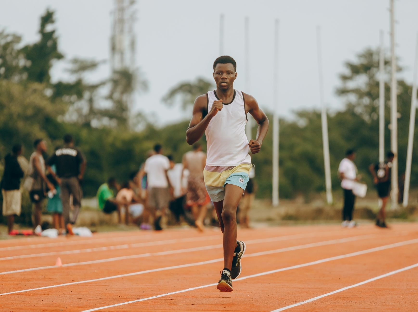 Young athlete training on an outdoor track in Lagos, showcasing dedication and speed.