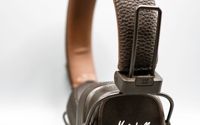 Brown Marshall on-ear headphones with a textured leather-look band and square cup on a white background