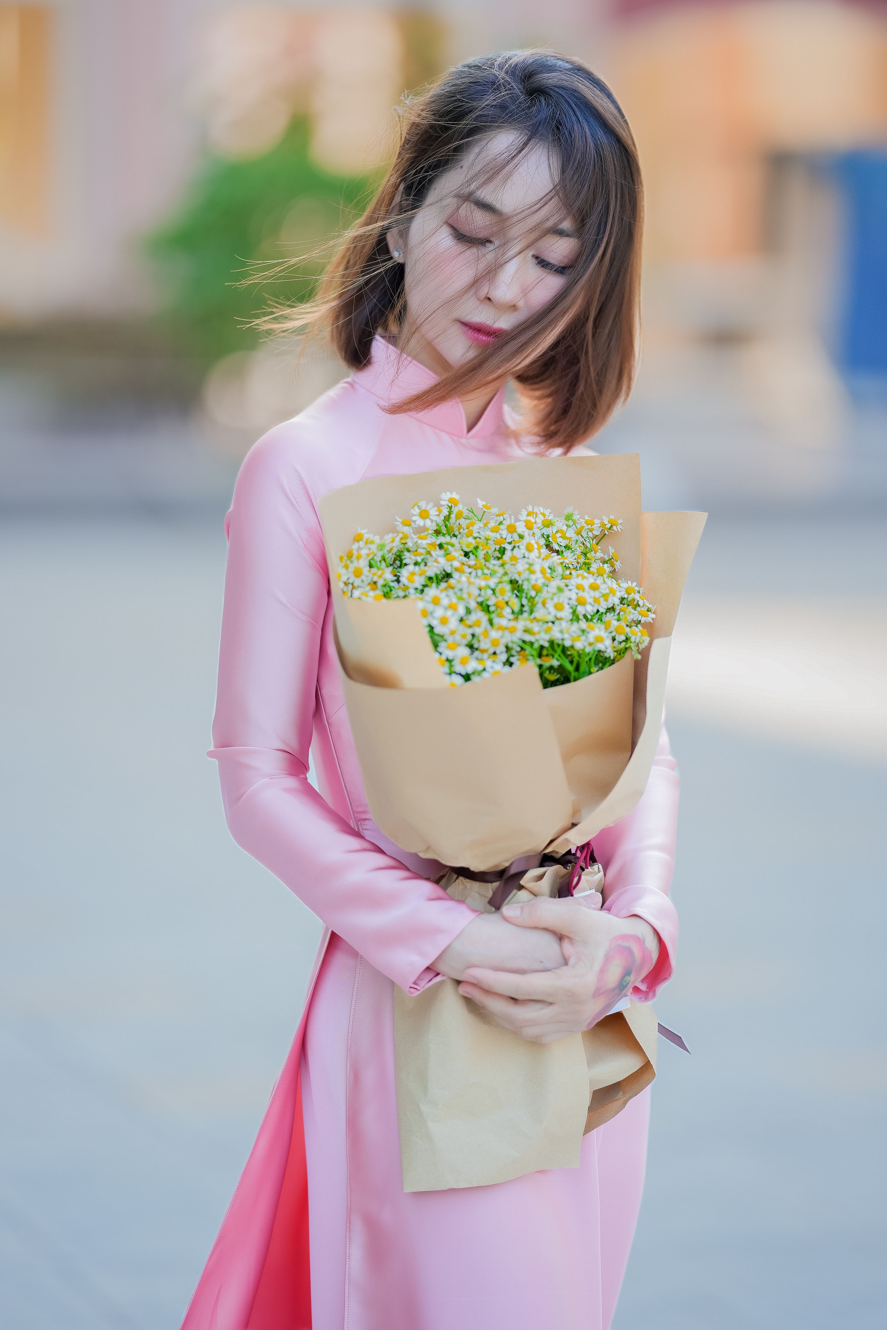 Woman in Pink Dress Holding a Bouquet Outdoors · Free Stock Photo