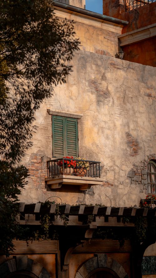 Free Charming rustic balcony with shutters and floral decor under warm light, Tokyo style. Stock Photo