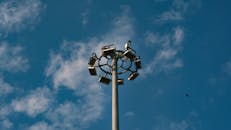 High Mast Lighting Pole Against Blue Sky