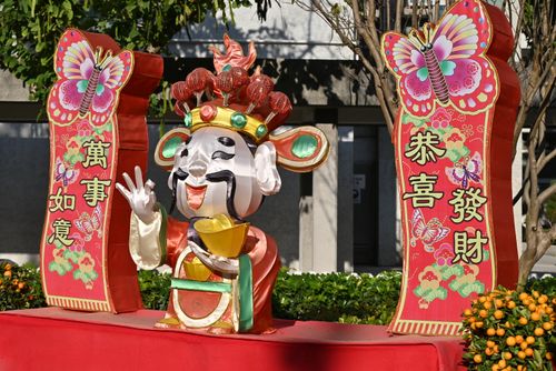 Free Vibrant outdoor Chinese New Year display with festive figures and symbols. Stock Photo