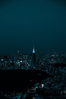 A stunning night view of Shibuya, Tokyo, showcasing the vibrant city lights and iconic architecture.
