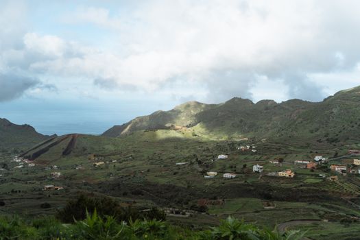 Picturesque view of a green valley with traditional houses on the Canary Islands.