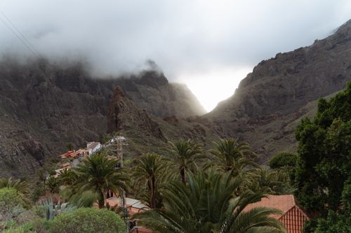 Free Dramatic view of Masca Village amidst rugged mountains and moody clouds in the Canary Islands. Stock Photo