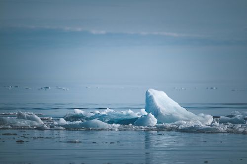 Free Peaceful scene of icebergs floating in Arctic waters during daytime. Stock Photo