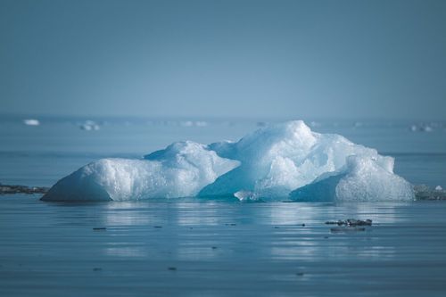 Free A serene iceberg floating in arctic waters, showcasing the natural beauty of ice formations. Stock Photo
