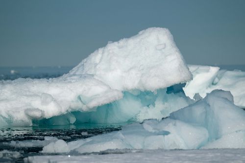 Free Capture of a large iceberg floating majestically in the sea, showcasing nature's beauty. Stock Photo